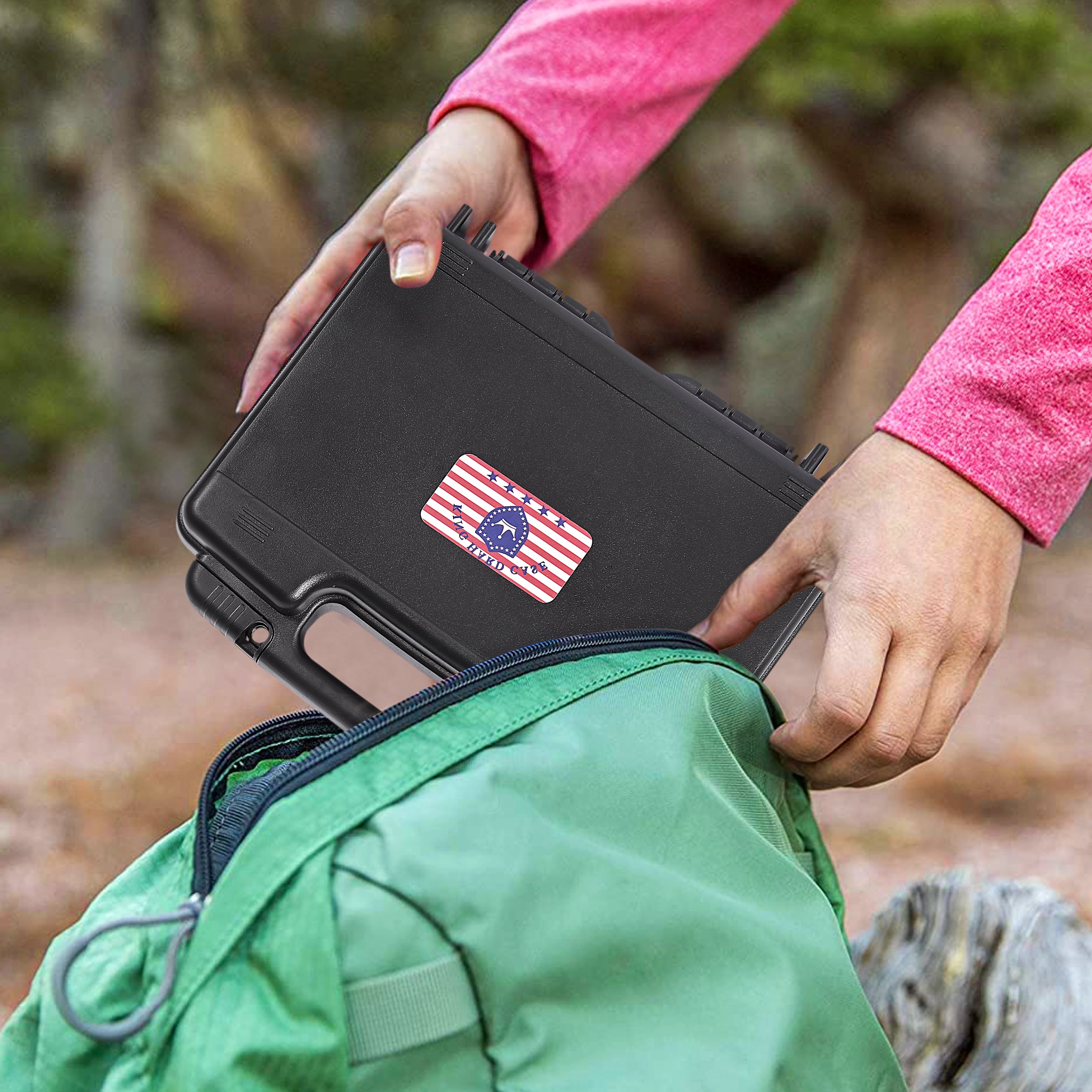 Person placing the lightweight and portable 10-inch waterproof weapon case into a backpack for easy carrying and travel to the range.