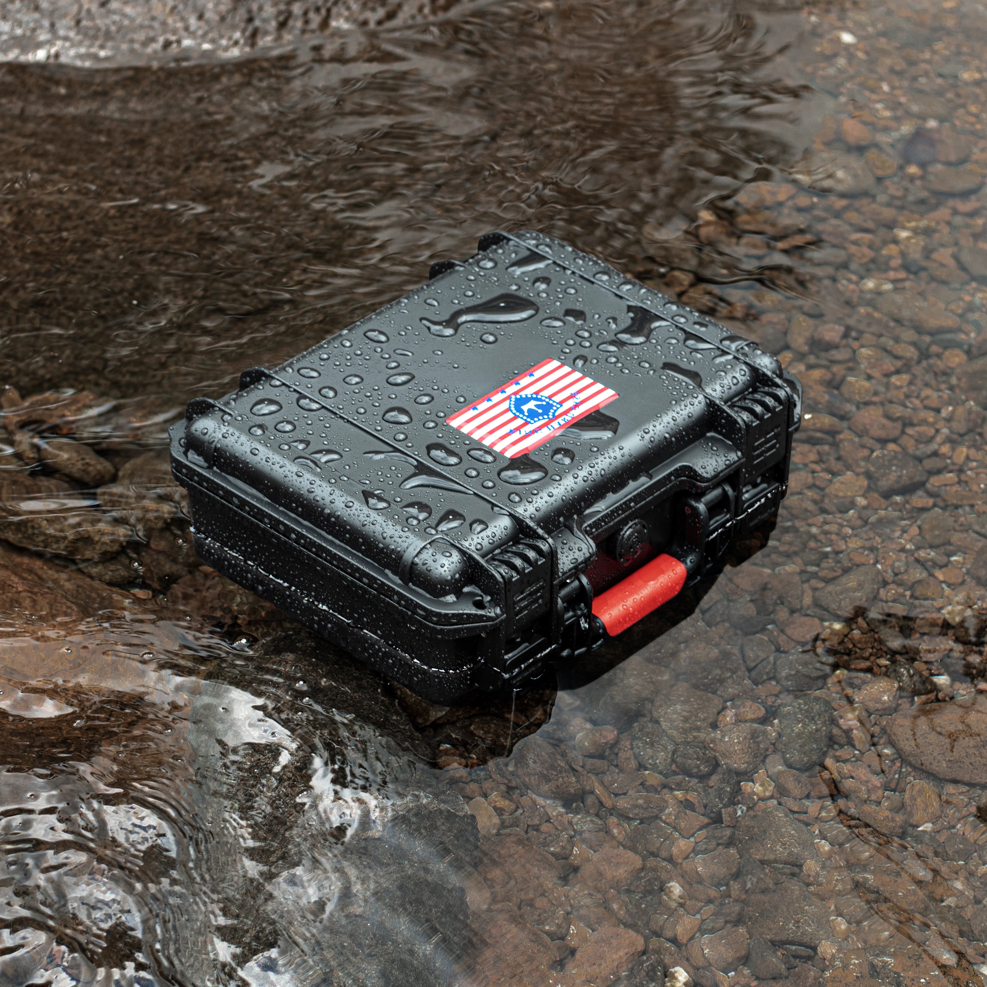 Rugged 11-inch waterproof ammo case sitting in water, demonstrating its IP67 waterproof rating and thickened rubber ring protection.