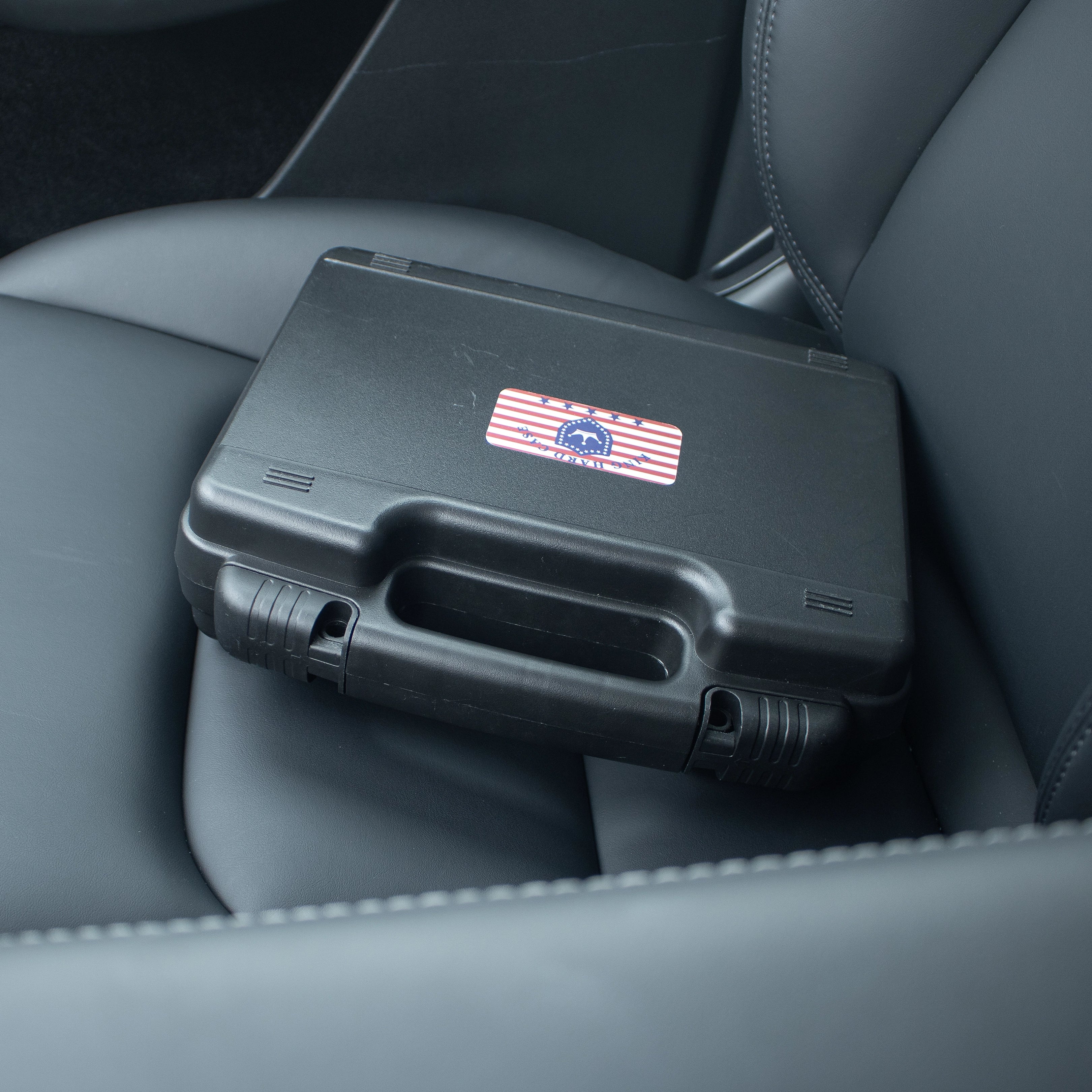 Portable 10-inch black waterproof weapon case placed on a car seat, highlighting its compact design for everyday commute and travel.