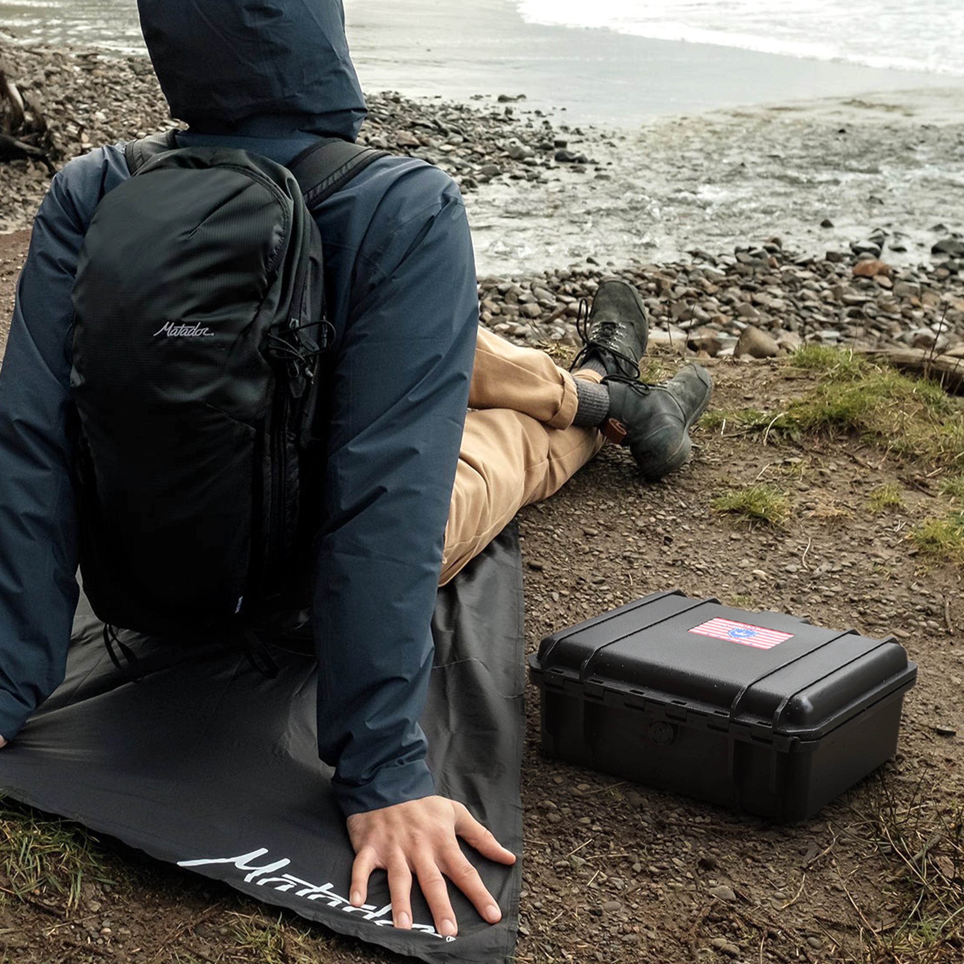 Rugged 11-inch waterproof ammo case used outdoors, highlighting its IP67 rating, anti-collision design, and travel-friendly portability.