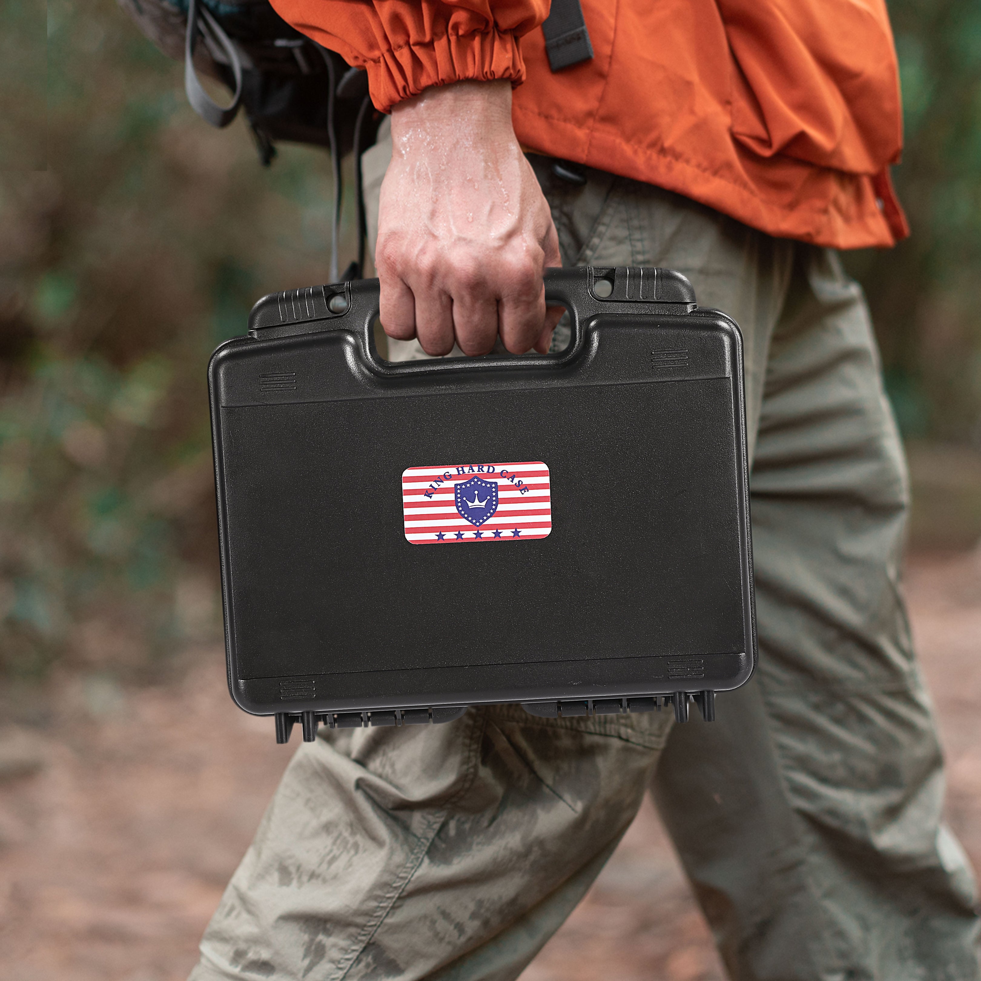 Person carrying the portable waterproof weapon case outdoors, highlighting its rugged design and secure dual lock holes.